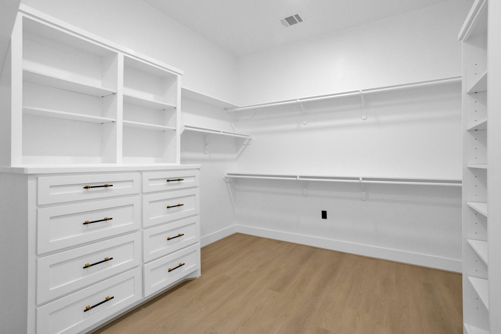 Large custom walk-in closet with built-in shelving and drawers