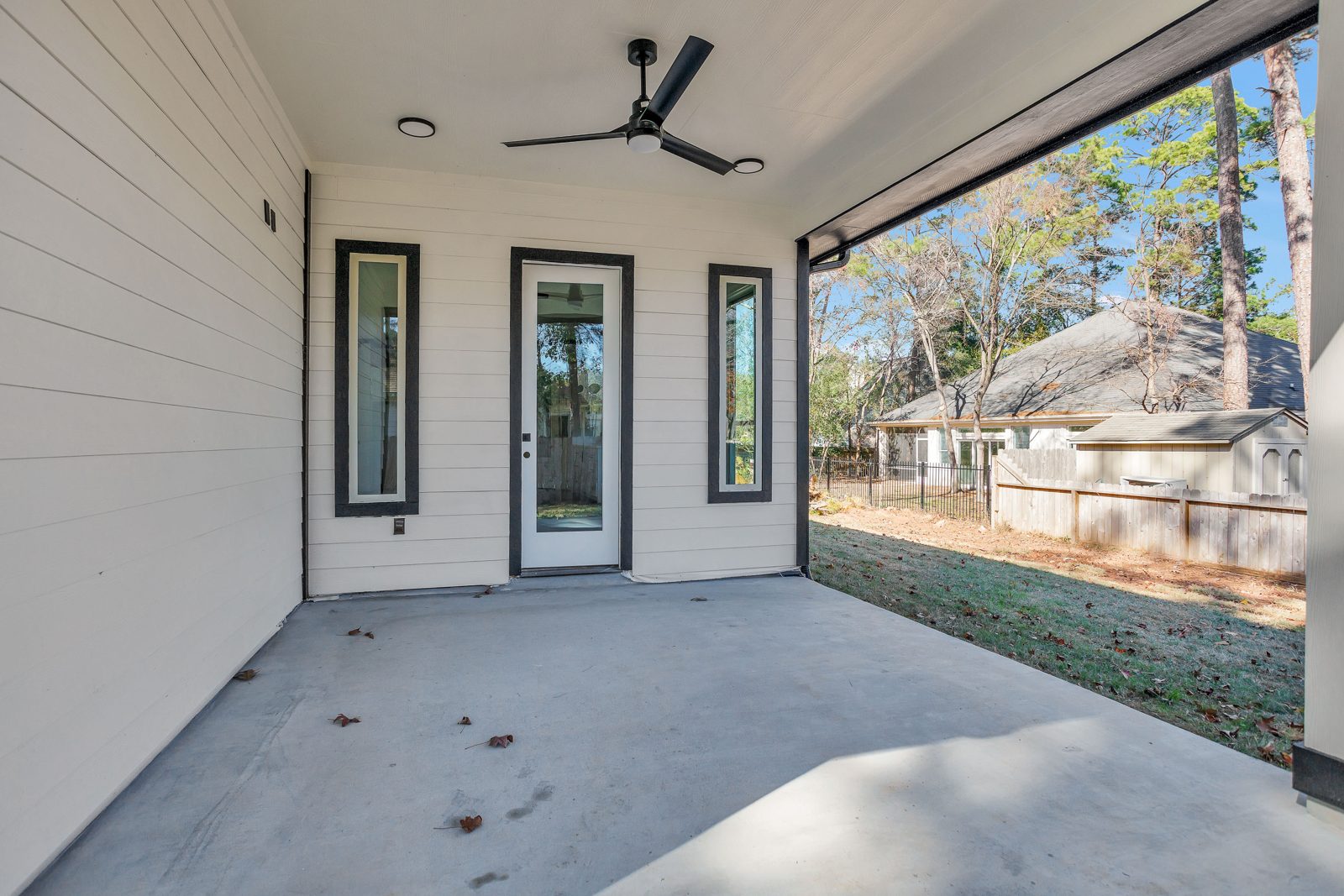 Covered rear patio with shiplap ceiling and view of the backyard